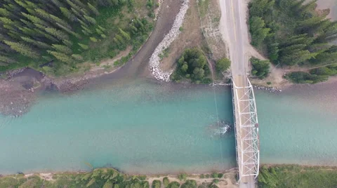 4K Aerial drone dramatic shot of a river and a bridge in Banff National Park Stock Footage 54949924