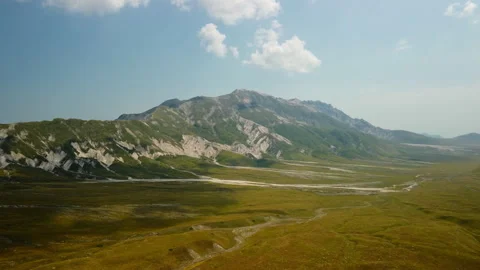 4K aerial drone flight forward over mountain valley with yellow and green fields Stock Footage 315206010