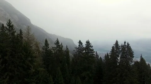 4K aerial drone flight over Innsbruck in snow weather showing mountain fir trees 스톡 동영상 80438445