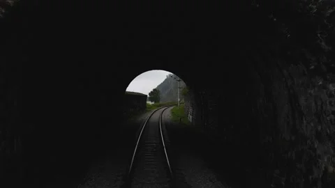 4K Aerial drone flight through a small gloomy stone tunnel with railway tracks. Stock Footage 159188764