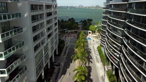 4K Aerial Drone Flying Between Buildings in Downtown Miami, Florida Palm Trees Stock Footage 165090449