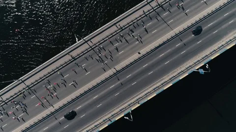 4K Aerial drone fooage. Marathon running on the bridge. Camera rotate top view Stock Footage 89825144