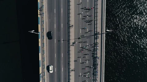 4K Aerial drone fooage. Marathon running on the bridge. Vertical dolly shot top Stock-Footage 89825305