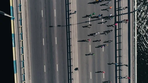 4K Aerial drone fooage. Marathon running on the bridge. Camera rotate top view Video stock 89825607
