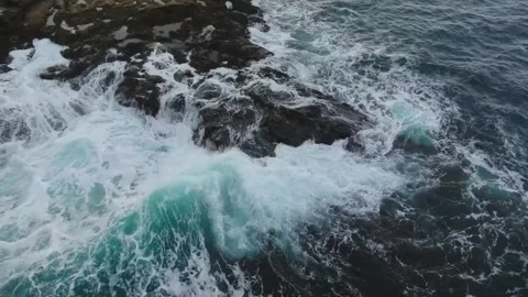4K aerial drone footage capturing waves crashing along rocky coastline at Cape Z Stock Footage 308935099