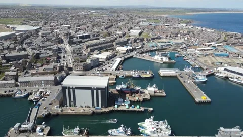4K aerial drone footage of Peterhead Harbour fishing boat repair yard, Scotland Stock Footage 336999901