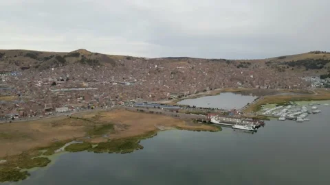 4K Aerial Drone Orbit Arc over Lake Titicaca and Puno, Peru at Sunrise Stock Footage 239835346