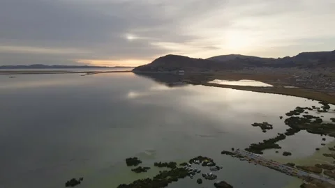 4K Aerial Drone Orbit Arc over Lake Titicaca and Puno, Peru at Sunrise Stock Footage 239835367