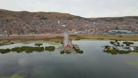 4K Aerial Drone Orbit Arc around Pier at Lake Titicaca in Puno, Peru in morning Stock Footage 239835377
