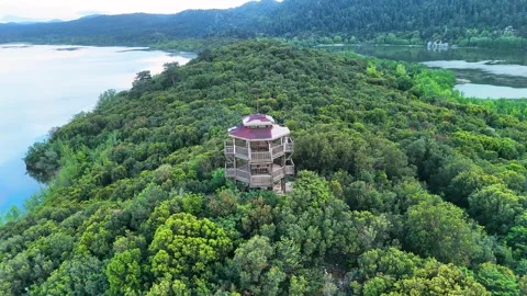 4K aerial drone orbit of observation tower at Kovada Lake surrounded by forest Stock Footage 336315130