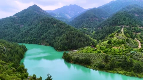 4K aerial drone orbit of turquoise river and forest landscape in mountains Stock Footage 336314437