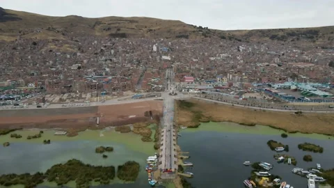 4K Aerial Drone Pull Back over Pier at Lake Titicaca in Puno, Peru, morning Stock Footage 239835356