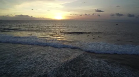 4K Aerial Drone Rise Pull Back Shot of Surfers in Uluwatu Bali Indonesia Vídeo Stock 64164289