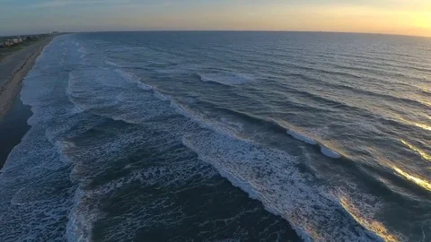 4k aerial drone seascape view on warm sunrise over calm white foamy wave of Stock Footage