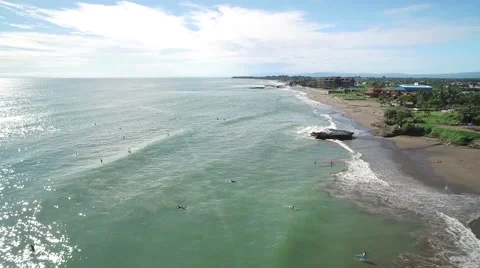 4K Aerial Drone Tilt Down Shot Over Surfers at Batu Balong in Bali Indonesia Vídeo Stock 64164246