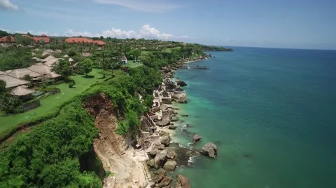 4K Aerial Drone Tilt Down Shot of Beach at Ayana Resort Bali Indonesia Vídeo Stock 64164401