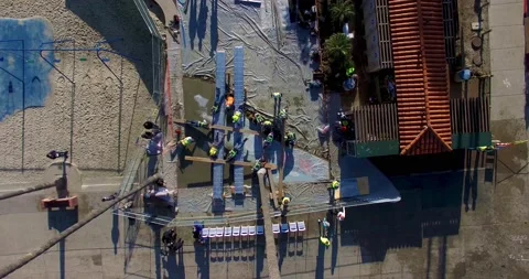 4K aerial drone top down zooming out view of construction workers at site Stock Footage 151933587