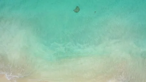 4K Aerial drone top down view bird eye view of sea blue waves break on rock and Stock Footage 255864098