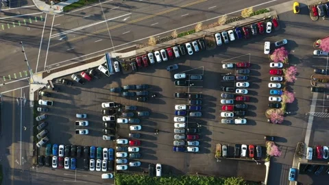 4K aerial drone top-down video footage of a crowded car dealership parking lot Stock Footage 306837906