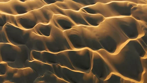 4K aerial drone view flying by beautiful wavy sand dunes in golden sunset light 스톡 동영상 134476541