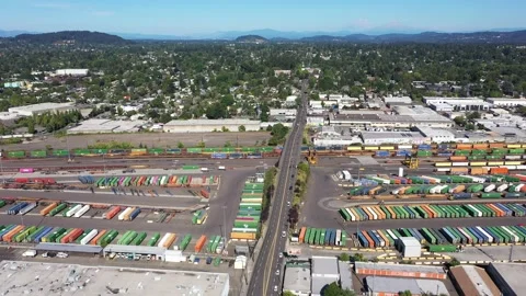 4K aerial drone view of freight train rail yard, public transit bus facility USA Stock Footage 345625452
