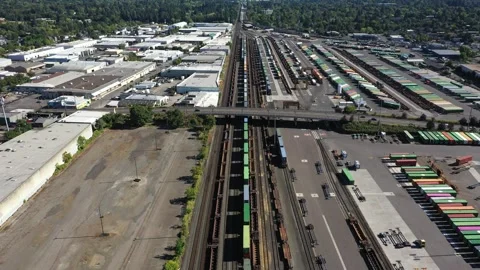 4K aerial drone view of freight train rail yard, public transit bus facility USA Stock Footage 345625781