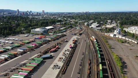 4K aerial drone view of freight train rail yard, public transit bus facility USA Stock Footage 345625849