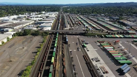 4K aerial drone view of freight train rail yard, public transit bus facility USA Stock Footage 345625860