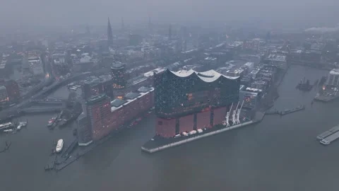 4K aerial drone view of HafenCity and the Philharmonic on a snowy evening Stock Footage 259296565