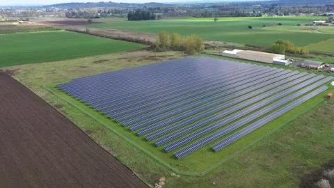 4K aerial drone view of a large solar panel farm in field in rural Oregon, USA  Stock Footage 332120224