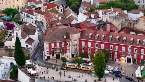 4K Aerial drone view of Lisbon yellow Trams and Alfama historic district 動画素材 320620439
