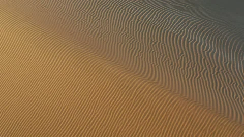 4K aerial drone view on wavy texture on the sand dunes at desert on sunset Video stock 134476363