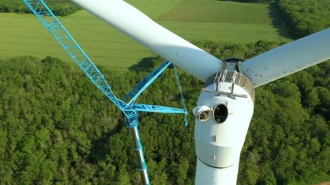 4K aerial drone view of a wind farm as industrial maintenance is undergoing. Stock Footage 195657395