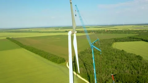 4K aerial drone view of a wind farm as industrial maintenance is undergoing. Stock Footage 199434737