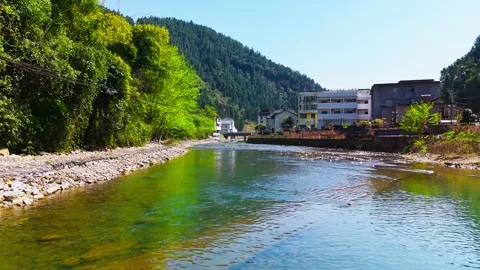 4K aerial of emerald river winding through lush green mountains. Stock Footage 330516441