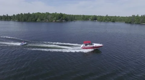 4k aerial fast boat pulls tube with two people Stock Footage 64988031