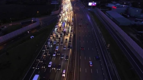 4K Aerial, flight over slow flow of cars in traffic jam on highway at night. Видео 107370673