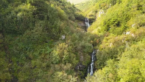  4K .Aerial. Flight  over small waterfalls in  mountain hills. Beauty of  nature Stockbeeldmateriaal 119099795