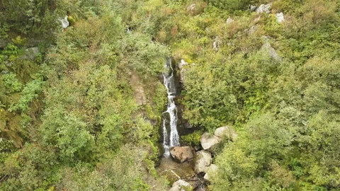 4K .Aerial. Flight over small waterfalls in mountain hills.  Vidéo 119308463