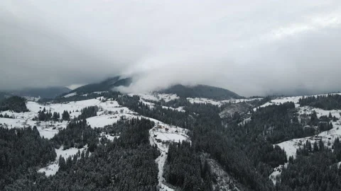 4k Aerial flight winter snow covered forest mountains village stormy nature 4k Stock Footage 220613682