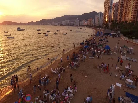 4K Aerial fly over a busy touristic beach in Mexico during a beautiful sunset Stock Footage