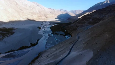 4k aerial fly over river system in dry mountain area in Ladakh in India Stock Footage 107615587