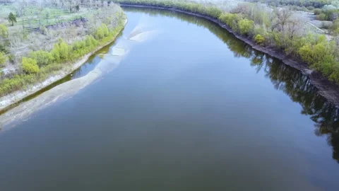      4K  Aerial. Fly  over river in fields. Landscape Stockbeeldmateriaal 129492755