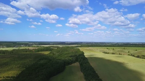 4K  Aerial.  Fly over spring  green field . Agricultural fields Stockbeeldmateriaal 90750568