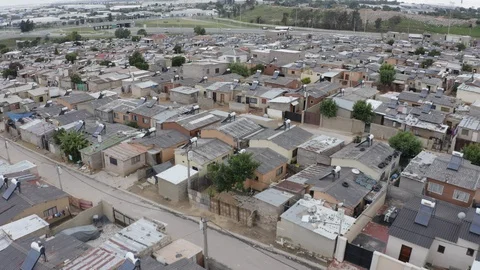 4K aerial fly over view of low cost housing with Solar water heaters on Stock Footage 102767961