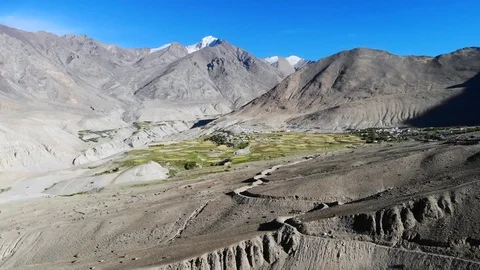 4k aerial fly through dry valley with green settlement in Ladakh in India Stock Footage 107615089