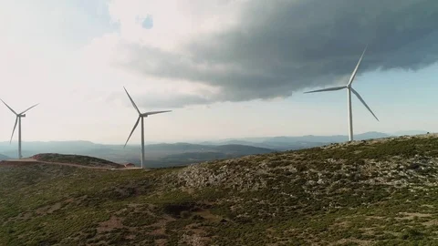 4K Aerial flyby big wind turbines on top of a hill Stock Footage 80931782