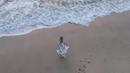 4K Aerial Flying Above Beautiful Woman On The Beach Stock Footage