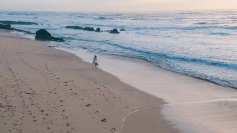 4k Aerial Flying Above Beautiful Woman Running On The Beach &amp; Ocean Stock Footage 80988976