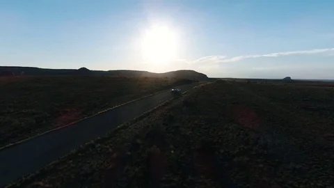 4k Aerial Flying Above White Convertible Car Driving Along America Highway Video stock 79594859